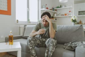 Military member drinking alcohol.