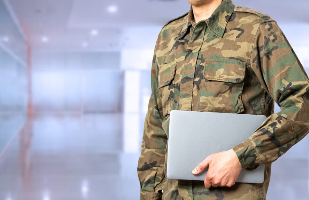 Close up soldier with laptop at academy with copy space