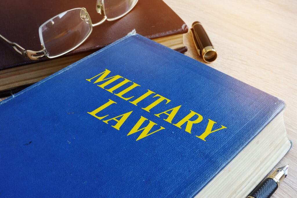 Military Law code on a desk.