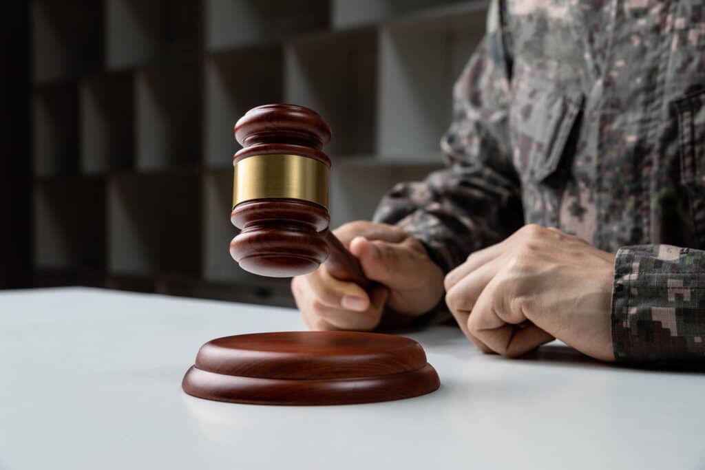 Hand of soldier holding gavel
