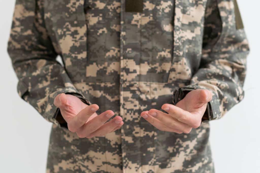 Closeup Shot Of Hands Of Unrecognizable Soldier In Camouflage Army Uniform, Military man.
